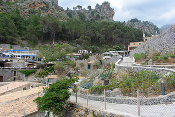 Obraz premium Sa Calobra, Mallorca, Spain - 05.05.2022: Houses and tourists in Sa Calobra, Mallorca, Spain