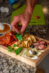 hand holding a bowl of dried fruits