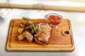 Grilled tasty meat steak on a cutting board. Barbecue