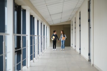 Happy school kids in corridor at school