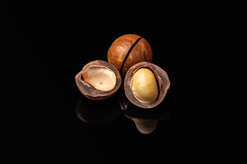 macadamia nuts on a black mirror background