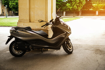 parked modern scooter in the courtyard of the house. electric moped