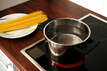 spaghetti pot on induction hob. home italian cuisine
