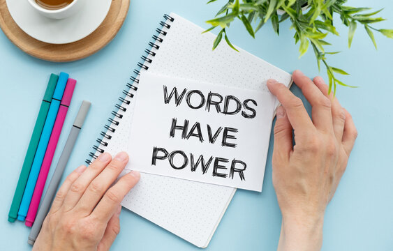 Words have power text on notepad and red pencil