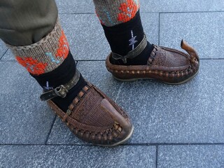 Man wears traditional handcrafted leather shoes