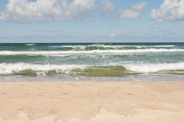 Baltic Sea - view from the beach to the sea with waves on a sunny day