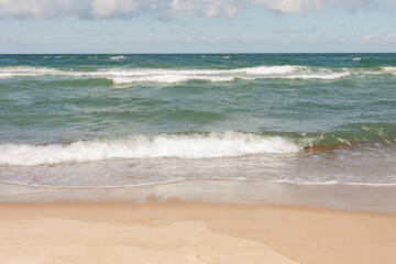 Baltic Sea - view from the beach to the sea with waves on a sunny day