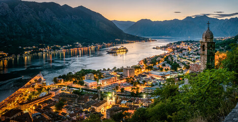 Panoramic evening view of the church, the old town and the Bay of Kotor from above. The Bay of Kotor is the beautiful place on the Adriatic Sea. Kotor, Montenegro. - obrazy, fototapety, plakaty