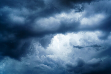 Naklejka na ściany i meble Storm clouds with a bright skylight in the center
