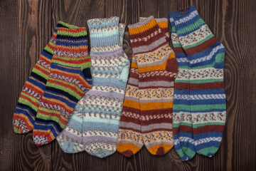 knitted wool socks on a wooden background top view