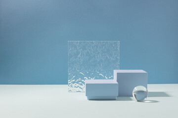 Abstract creative geometric podium from various materials, blue background hard shadows. Minimalism