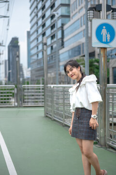 smiling woman standing happily in the park
