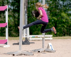 Zelfklevend Fotobehang Girl jumping on hobby horse. Equestrian sport. Jumping competition. Champion. Horse sport © mari