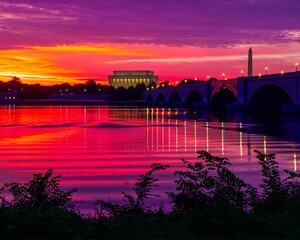 Night view of the Lincoln Memorial in Washington D.C with red sky reflecting over water