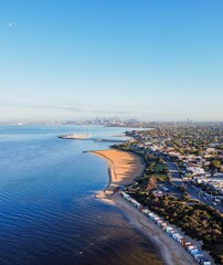 Fototapeta premium Aerial view of the Brighton Beach Boxes and Melbourne Skyline at sunri