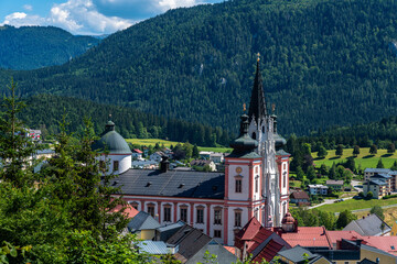 Beautiful aerial view of Mariazell Basilica, a Roman Catholic church, on sunny summer day with the Alps and blue sky cloud, Styria, Austria - 516448798