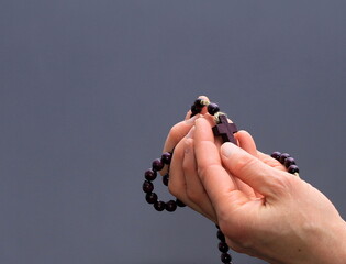 hand holding cross praying to god stock photo