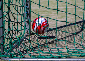 Soccer ball in the green goal net of a soccer goal