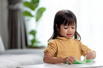 Kid play with handgum. Slime in children hands.