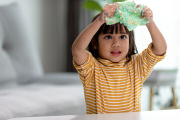 Kid play with handgum. Slime in children hands.