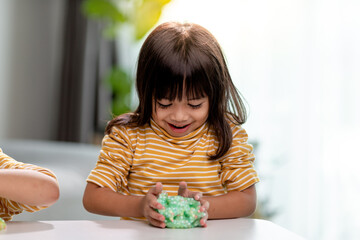 Kid play with handgum. Slime in children hands.