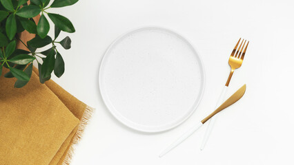 Empty plate with fork and knife on white background. Top view.