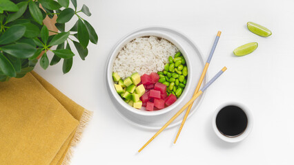 Hawaiian poke bowl with tuna, rice, edamame beans, tomato, lime and avocado.