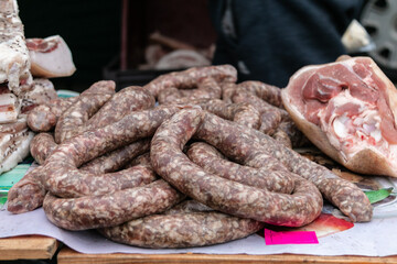 Homemade sausage on the counter of the village market. Selling products on the market. Close-up.