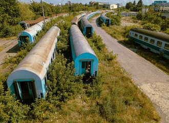 Abandoned train station and rusty abandoned train cars.