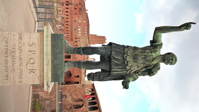Statue of Augustus Caesar with ancient buildings on the background in Rome, Italy