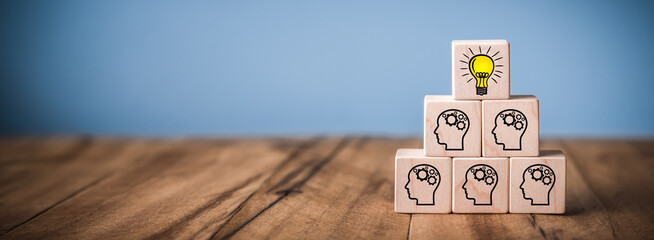 Wooden Blocks on Table With Team And Lightbulb Symbol - Success Through Teamwork Concept 