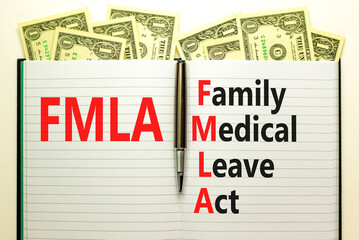 FMLA family medical leave act symbol. Concept words FMLA family medical leave act on white note on beautiful dollar background. Businessman hand. Medical FMLA family medical leave act concept.