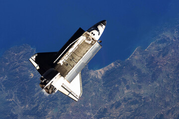 Space shuttle, above the Earth. Elements of this image furnished by NASA
