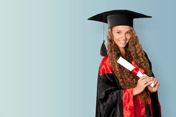 Cute female wearing graduation cap and ceremony robe with certificate diploma. Graduate celebrating graduation. Education Concept. Successful elementary school