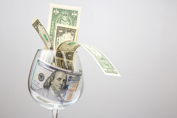dollar money in an empty wine glass. Online business sale. Financial success in the trading business.
