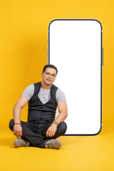 Mobile template. Young man with phone. Big smartphone behind man. Cellphone with white screen. Mobile phone it with copy space. Phone number for your website. Smartphone template. Cellphone on yellow