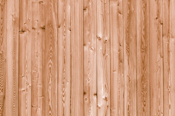 Vintage fence of old wooden boards. Texture of an aging wooden surface. Beautiful wooden background.