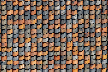 Red tiles background details, Old orange and dark brown roof brick under the sun, Shingles texture, Abstract geometric pattern, Roof top material. - obrazy, fototapety, plakaty