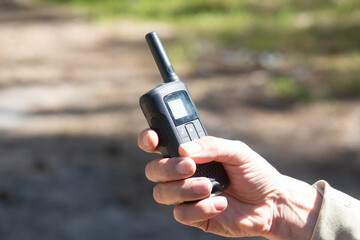 Walkie-talkies.Using walkie-talkies in the forest to transmit messages. - obrazy, fototapety, plakaty