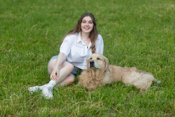 Girl with a dog, Golden Retriever. A girl with a dog in the park.