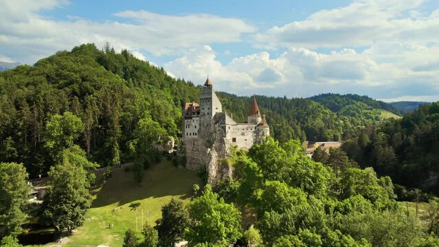 Aerial drone view of The Bran Castle in Romania. Medieval castle in Carpathians, green trees around