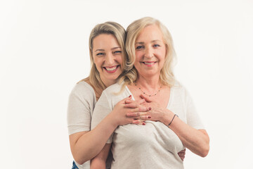 Two attractive women in their 40s hugging and looking at each other affectionately, holding hands, interlaced fingers. . High quality photo