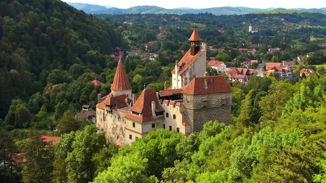 Aerial drone view of The Bran Castle in Romania. Medieval castle in Carpathians, green trees around
