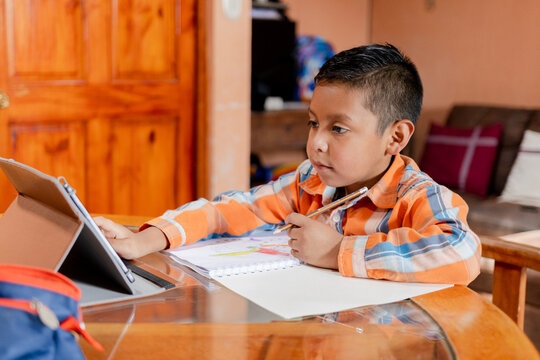 Hispanic Boy Doing Homework At Home - Preschool Toddler Boy Drawing - Home Schooling - Kid Learning Online With Tablet