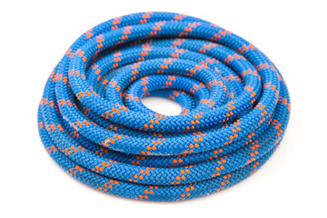 durable colored rope for climbing equipment on a white background. coil of braided cable. item for tourism and travel
