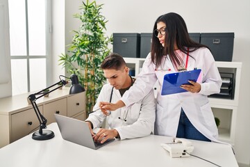 Fototapeta premium Man and woman wearing doctor uniform working at clinic