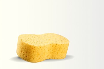Yellow soft bath sponge on the desk