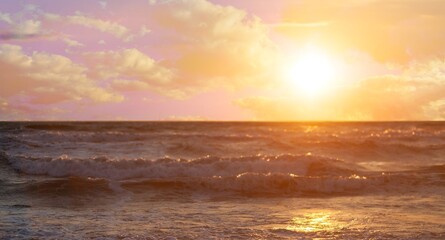 Obraz premium Beautiful sea at sunset. Dramatic sky with glowing clouds. Setting sun. Abstract natural