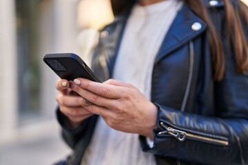 Young woman using smartphone at street