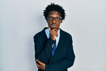 Young african american man wearing business suit and tie puffing cheeks with funny face. mouth inflated with air, catching air.